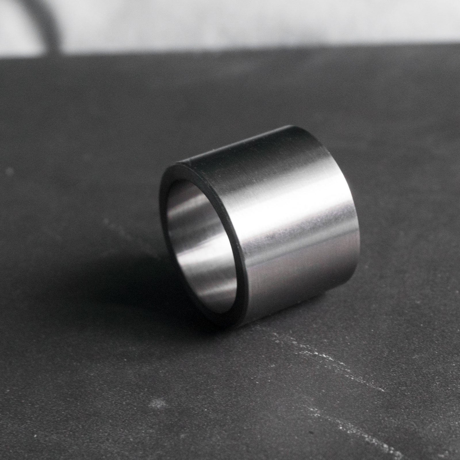 This is Bastion, a minimalist and imposing ring, handcrafted from pure tantalum, a rare, everlasting metal with a dark grey hue.