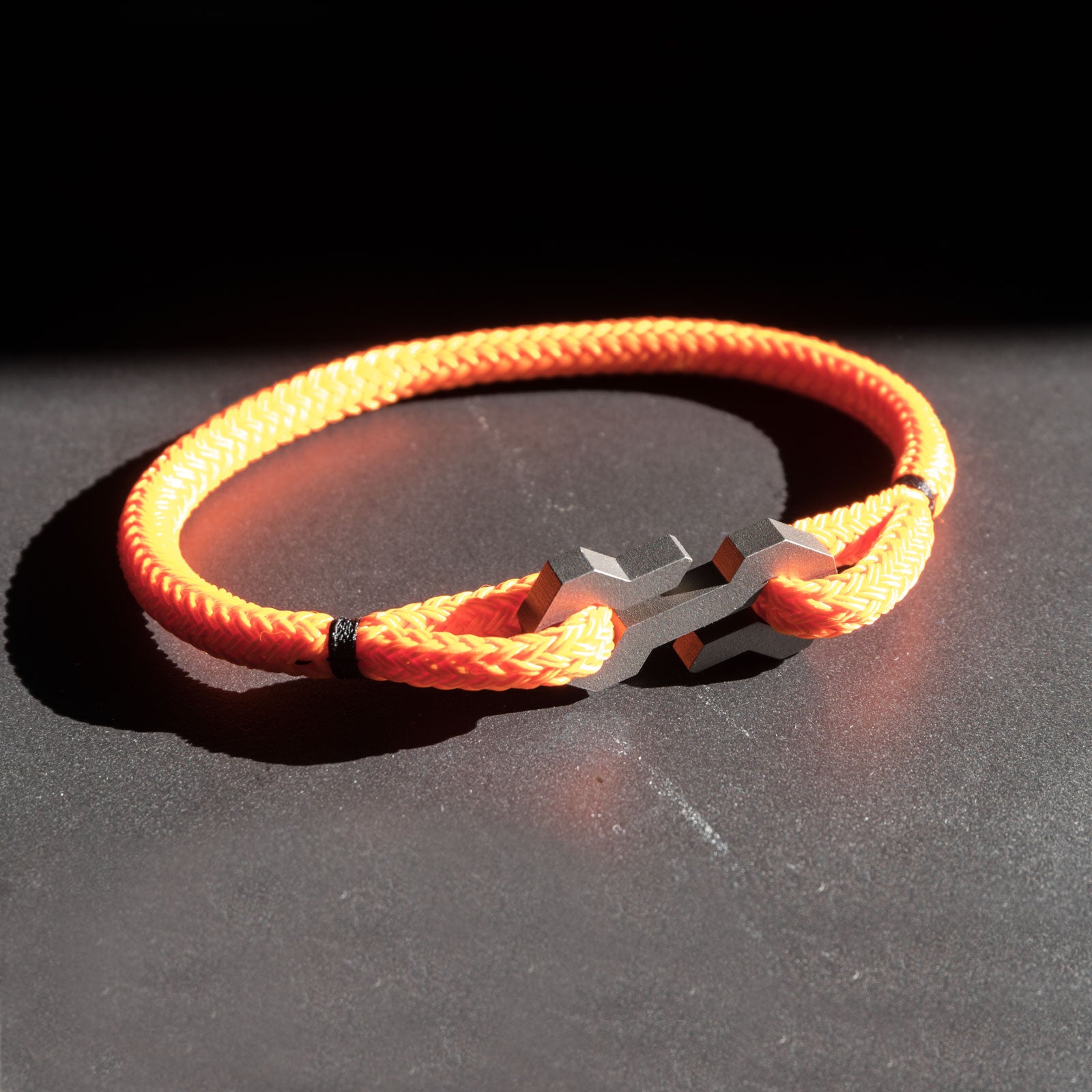 The Type S is a minimalist and timeless rope bracelet, handmade from grade 5 titanium and a nearly indestructible rope. The clasp takes cues from the traditional s-hook clasp, with sharper lines and angles. The Type S securely ties and holds the rope, making it a very secure and comfortable fit on the wrist. The radiant color of the rope perfectly matches the subdued tones of the titanium.