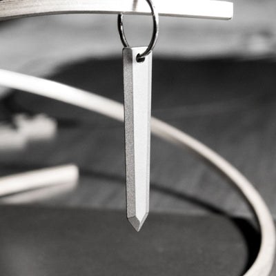 Guts' sword. Massive, thick and light. A minimalist take with faithful proportions, it is made from grade 5 titanium, meaning that it is super light to wear and is biocompatible.