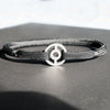 A faithful 2D rendition of the Pokeball, remade as a clasp for a bracelet. Slide the rope through the hidden opening so that it sits on the sides. Entirely handcrafted from grade 5 titanium.