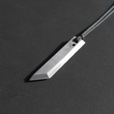The sword's blade of a legendary hero. A minimalist take with faithful proportions, save for a few details like the two slightly bigger holes, required to make it wearable as a pendant.