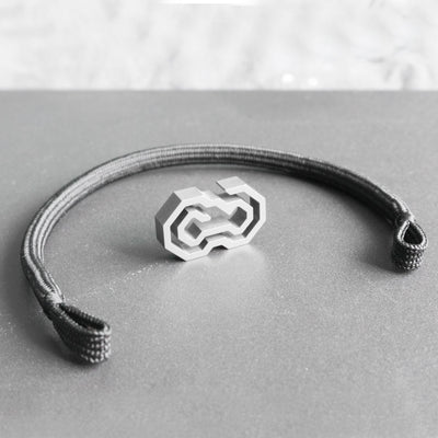 The Daidalos is a minimalist, timeless rope bracelet, handmade from grade 5 titanium and a nearly indestructible rope.  Both clasp and rope have been designed and made for each other. They give the bracelet a balanced and homogeneous structure. The titanium clasp features a unique and innovative operating design. Slide the rope through the maze, until it reaches the center and securely nests itself. This is probably one of the safest jewelry locking/closing mechanisms in the world.