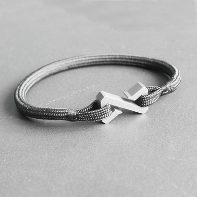 The Zenos is a minimalist and timeless rope bracelet, handmade from grade 5 titanium and a nearly indestructible rope. The titanium clasp is shaped after a broken hourglass, symbolizing time at a standstill. It is made to represent the impervious aspect of the bracelet, crafted to last forever.